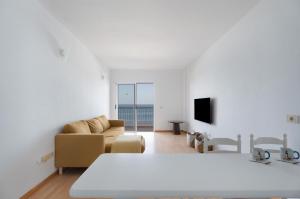 a living room with a bed and a couch at Bajamar - Apart-Piscina naturales in Bajamar