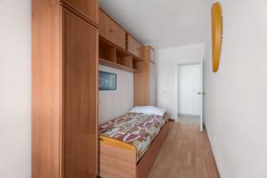 a bedroom with a bed in a wooden cabinet at Bajamar - Apart-Piscina naturales in Bajamar