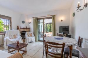 a living room with a table and chairs at Villa Margarita in Benissa