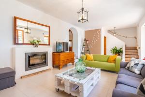 a living room with a couch and a fireplace at Els Garroverets in Binissalem