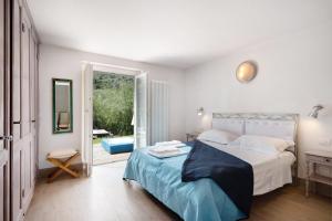 a bedroom with a bed with a blue blanket at Villa Nespolo in Levanto +25 photos