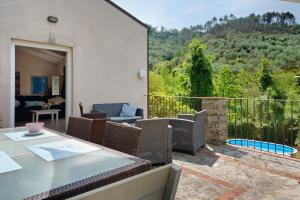 a patio with a table and chairs on a balcony at Villa Nespolo in Levanto