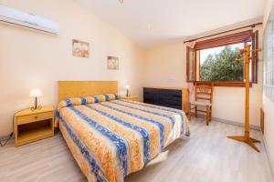 a bedroom with a bed and a window at Ses Angoixes in Santanyi +23 photos