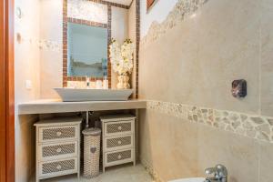a bathroom with a sink and a mirror at Villa Alice in Villasimius