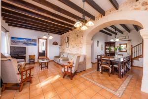 a living room filled with furniture and a table at Ses Angoixes in Santanyi