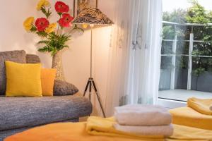 a living room with a couch and a window at B und E Röck in Meckenbeuren +5 photos