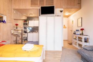 a living room with a tv on top of a white refrigerator at B und E Röck in Meckenbeuren