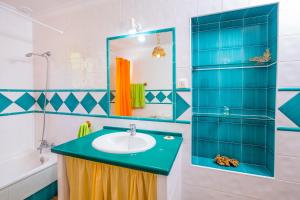 a bathroom with a sink and a mirror at Casa de María in El Palmar +22 photos