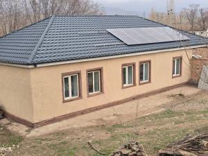 a house with a solar panel on top of it at Azis Hostel in Karatëbë +8 photos