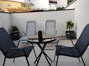 a patio with two chairs and a table and two chairs at Lorber house Štinjan - Studio in Pula