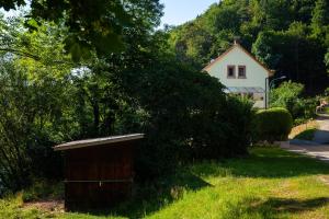 a smallshed in the grass in front of a house at Ferienwohnung Mengeler in Freiburg im Breisgau