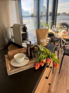 a table with a tray with a bowl and flowers on it at Hausboot mit Motorboot in Heiligenhafen +36 photos