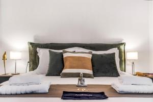 a bedroom with a bed with pillows and a table at Oceanida Afrodite Lyxury Suite in Nikiana +20 photos