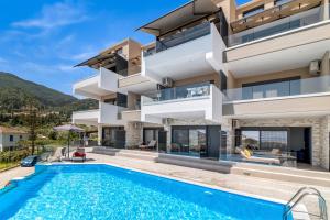 a luxury villa with a swimming pool at Oceanida Afrodite Lyxury Suite in Nikiana