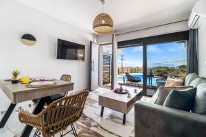 a living room with a couch and a table at Oceanida Afrodite Lyxury Suite in Nikiana