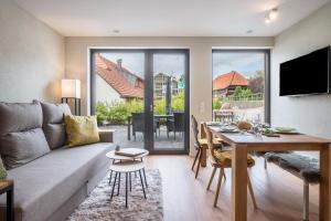 a living room with a couch and a table at Gold Haus in Weilheim