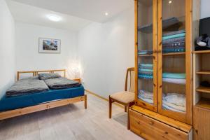 a bedroom with a bed and a wooden cabinet at Ferienwohnung Kurzentrum in Bad Lausick