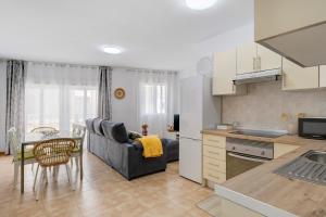 a kitchen and living room with a couch and a table at Campo Amor Alto in Arrecife