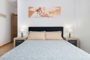 a bedroom with a large bed with two night stands at Campo Amor Alto in Arrecife