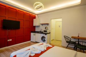 a living room with red walls and a kitchen at 1826 Heritage Suites in Taksim +15 photos