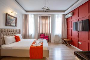 a hotel room with a bed and a tv at 1826 Heritage Suites in Taksim