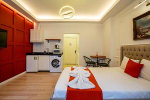 a hotel room with a bed and a kitchen at 1826 Heritage Suites in Taksim