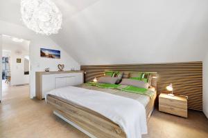 a bedroom with a large bed and a chandelier at Ferienwohnung Rosengarten in Mössingen