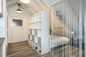 a room with a staircase with white shelves at Straub in Meckenbeuren
