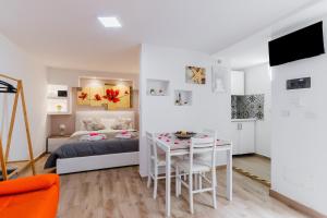 a bedroom with a bed and a table and a dining room at Luxury 12 in Tuglie