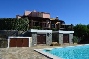 a house with a swimming pool in front of it at Villa Sofia in Cuile Pazzoni