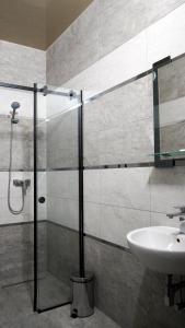 a bathroom with a glass shower and a sink at Відпочинковий - комплекс '"Замок Лева"" in Peremyshlyany +30 photos