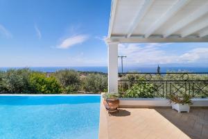 a swimming pool with a view of the ocean at Villa Belvedere Verde in Lefkada