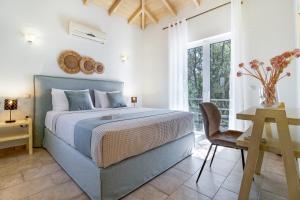a bedroom with a bed and a desk and a chair at Villa Belvedere Verde in Lefkada +24 photos