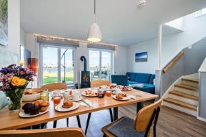 a dining room with a table with food on it at An der Ostsee by Seeblick Ferien in Kappeln