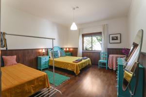 a bedroom with a bed and a table and chairs at Casa Tangerina in Tavira