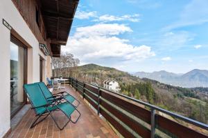 a balcony with a chair and a view of the mountains at Appartamento Gran Vista in Premeno