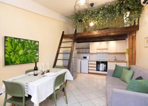 a dining room and living room with a table and a couch at Chelubirdi in Villasimius +15 photos