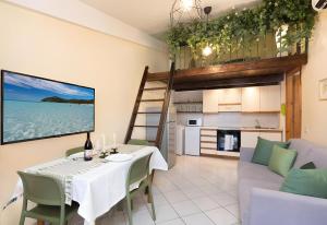 a dining room with a table and a kitchen at Chelubirdi in Villasimius