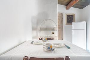 a table with two plates and a cup on it at Villa Rosa in Porto Rotondo