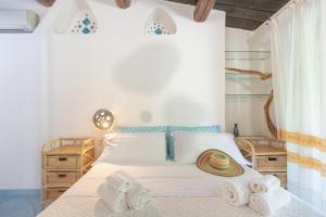 a bedroom with a bed with towels on it at Villa Rosa in Porto Rotondo