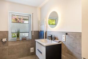 a bathroom with a sink and a mirror at Ferienwohnung-Bachlauf-Eslohe in Eslohe +14 photos