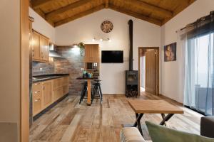 a kitchen with wooden cabinets and a wooden table at Los Almendr2s in Frontera