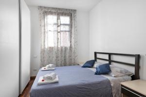 a bedroom with a bed with towels on it at La Villa in Mantova