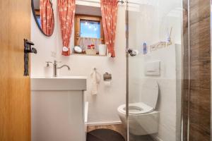 a small bathroom with a toilet and a sink at Fewo in Urspring am Lechstausee in Steingädele