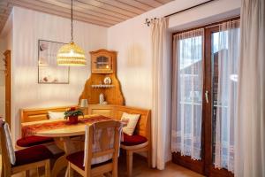 a dining room with a table and a table and chairs at Fewo in Urspring am Lechstausee in Steingädele +12 photos