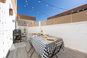 a table with a checkered table cloth on a patio at Apartamento Calma Suite in Albox