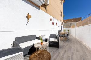 a patio with a couch and chairs and a table at Apartamento Calma Suite in Albox