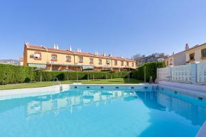 a large swimming pool in front of a building at Casa del mar Salobreña in Salobreña