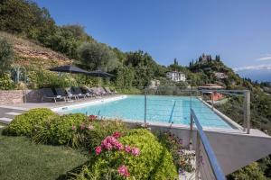 a swimming pool with a view of a mountain at Villa Agave exclusive pool in Toscolano Maderno