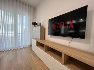 a living room with a television on a wall at Comfort Zone in Mestre